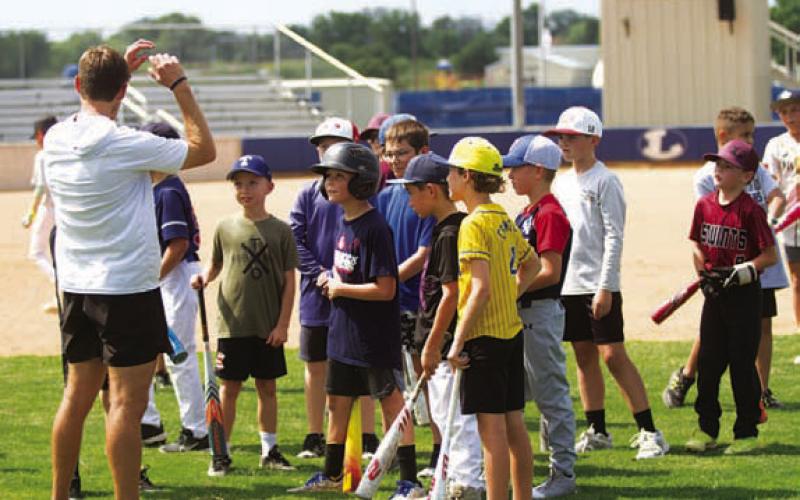HUNTER KING | DISPATCH RECORD Baseball players receive instruction at the youth camp this week.
