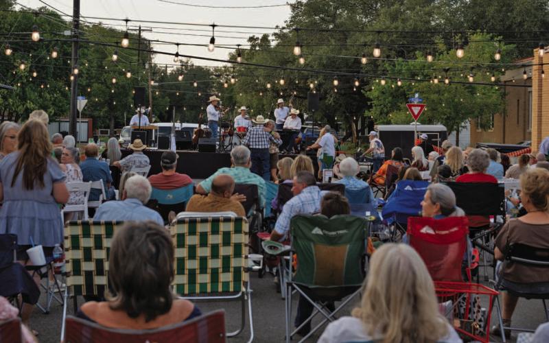 Western Night on Western attendees enjoy relaxing in their chairs while listening to the tunes of the Jason Roberts Band. ADAM BARRIOS| DISPATCH RECORD