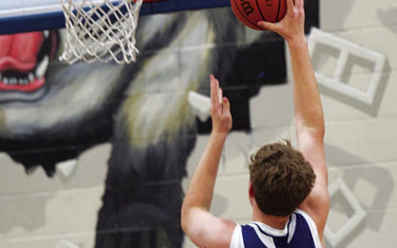Beau Patterson rises up toward the rim to finish off two points in spring league action. HUNTER KING | DISPATCH RECORD
