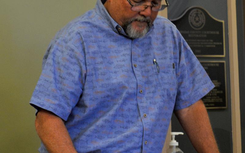 Hill Country 100 Club Director Jim Lindeman highlights the organization’s efforts in a presentation during last week’s Lampasas County Commissioners Court meeting. erick mitchell | dispatch record