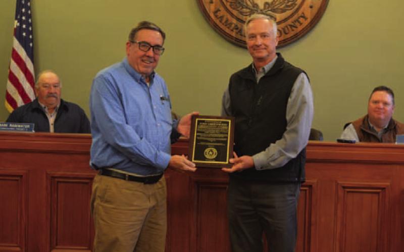 Outgoing Lampasas County Attorney John Greenwood, at left, was recognized by the Lampasas County Commissioners Court at its last meeting for his service to the community. He is pictured with County Judge Randy Hoyer. ERICK MITCHELL | DISPATCH RECORD