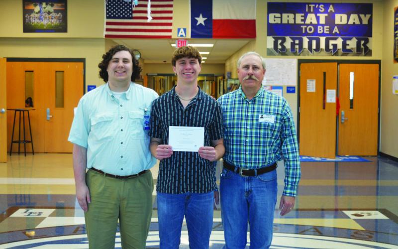 Cale Wheeler, in center, holds his National Merit Scholarship Finalist certificate. With him are his brother, Cole Wheeler, at left, and father Shawn Wheeler. ERICK MITCHELL | DISPATCH RECORD