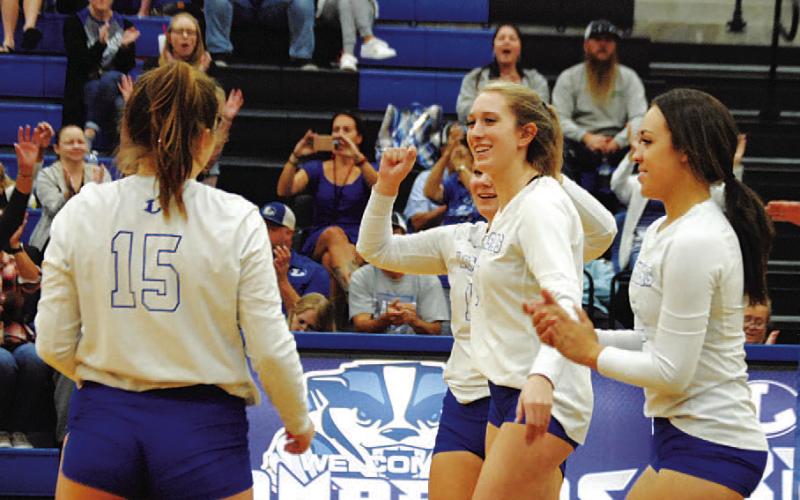Breana Pelbath and her teammates celebrate a point during Tuesday’s contest. HUNTER KING | DISPATCH RECORD