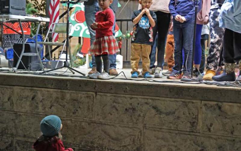 Carolers at this year’s Carol of Lights had a front-row fan who didn’t want to miss out on hearing a tune. joycesarah mccabe | dispatch record