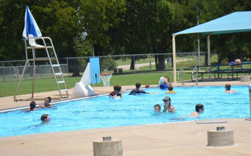 Swimmers of all ages cool off during a hot July at the Hanna Springs Pool. Upcoming events at the pool include the annual Dive-In Movie night and a Teen Scene social event. FILE PHOTO | DISPATCH RECORD