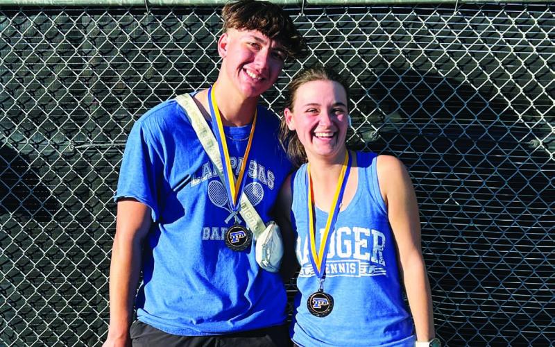 COURTESY PHOTO | KENNETH PEISER Clyde Ashfield, left, and Caroline White pose with their medals from last week’s tournament.