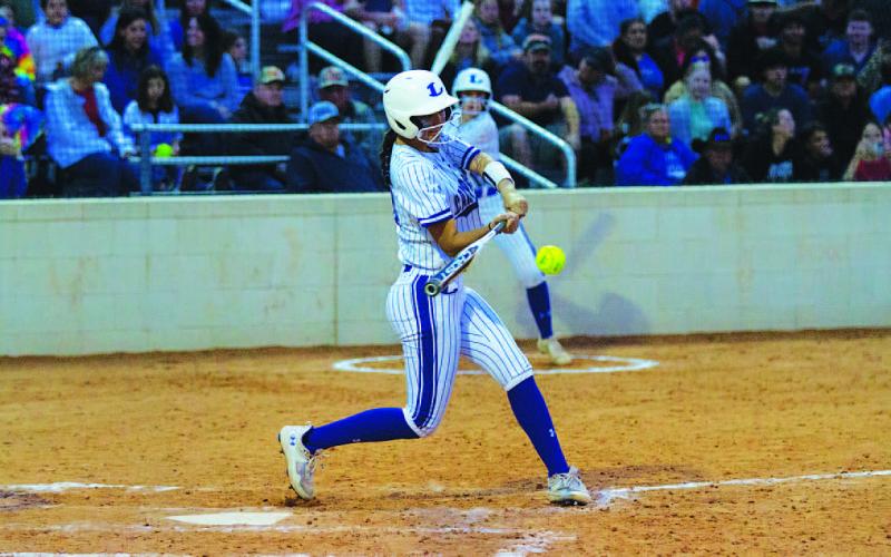 Madison Magilke smacks a single up the middle during the early innings of Tuesday’s contest. HUNTER KING | DISPATCH RECORD