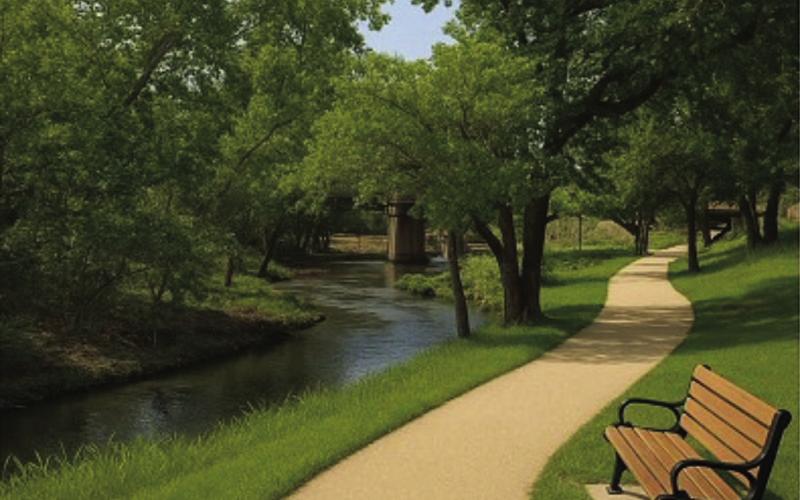 This artificial intelligence-generated photo offers an idea of what a walkway could look like along the meandering Sulphur Creek if the area near the Fourth Street bridge is cleared of invasive brush and maintained. See page 8 for a photo of the creekbank as it looks currently. COURTESY ILLUSTRATION | SHAWN KIRKPATRICK