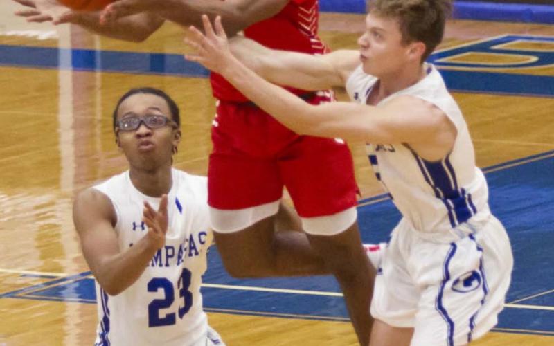 Niko Lewis (23) and Parker Gibbs (5) break up a Lake Belton pass in the second half of Saturday’s 69-54 Badger victory. JEFF LOWE | DISPATCH RECORD