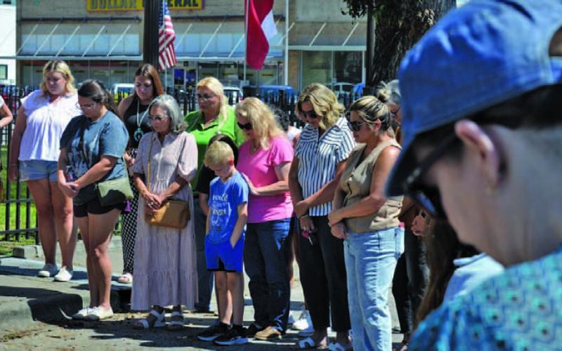 Lampasas residents gathered around the county courthouse Thursday in a moment of prayer for the nation 24 years after the Sept. 11 attacks and the day after the murder of Charlie Kirk, a conservative activist and Turning Point USA co-founder. ERICK MITCHELL | DISPATCH RECORD
