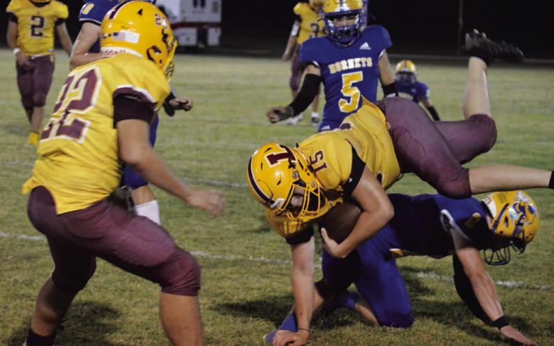 Jacob Wooten (15) gets upended after catching a pass. MASON HINES | DISPATCH RECORD