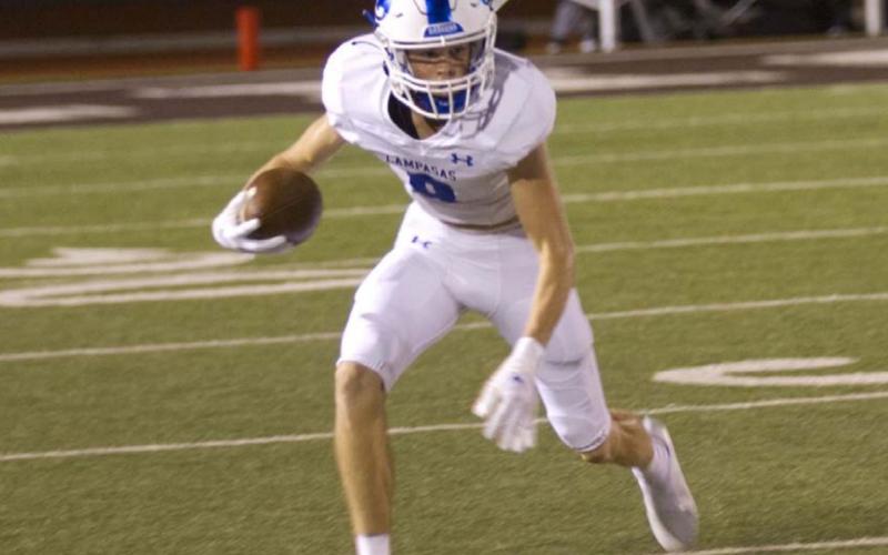 Nate Borchardt attempts to juke out a defender after making a catch during the season-opener against Brownwood. HUNTER KING | DISPATCH RECORD