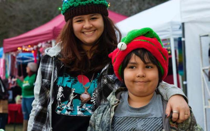 Pacincia Aguayo, at left, wears a colorful, lighted hat handmade by her grandmother to the Kempner Christmas in the Park. She’s pictured with sibling Rosalio Aguayo. Adam Barrios | Dispatch record