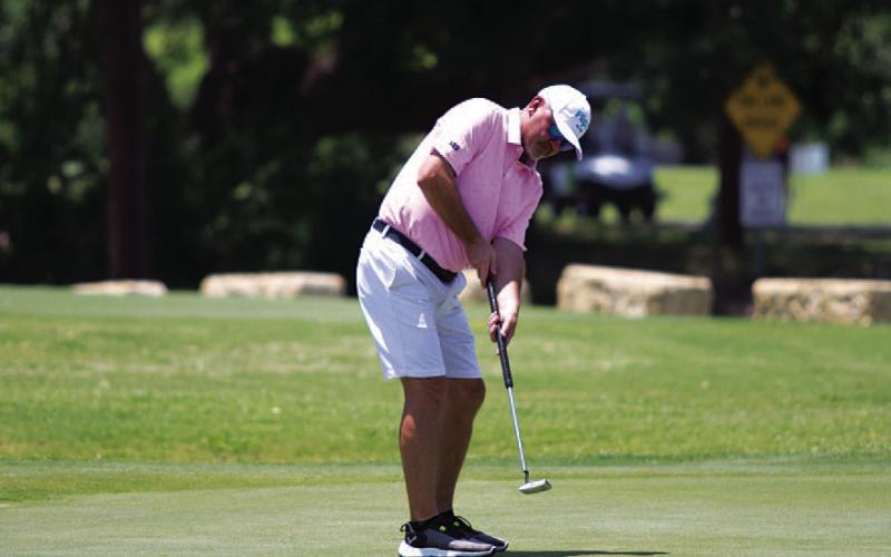 HUNTER KING | DISPATCH RECORD Mike Wiley watches a putt move toward the hole during the Memorial tournament.
