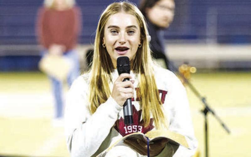 Lampasas high schooler Loretta Hodges reads from the Bible during last week’s Fields of Faith event. HUNTER KING | DISPATCH RECORD