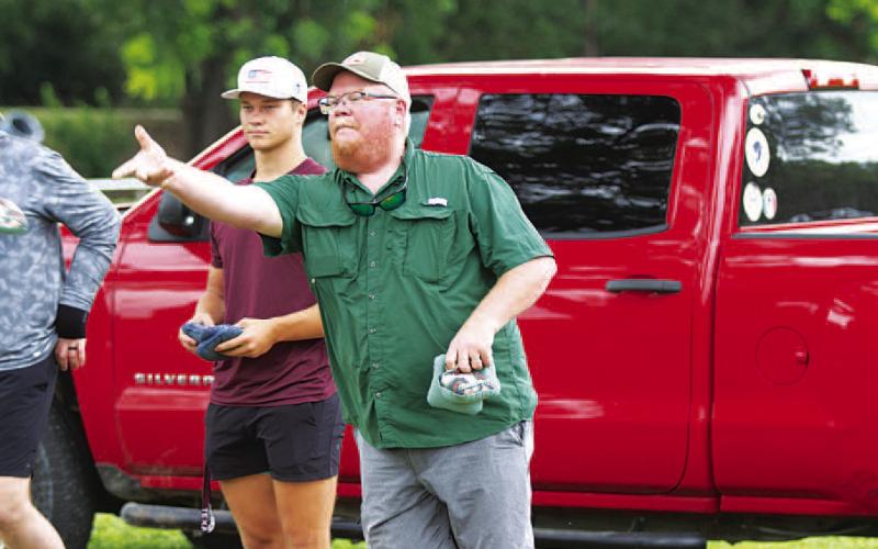 HUNTER KING | DISPATCH RECORD Trampus Isom tosses a bag during the cornhole tournament last Saturday.