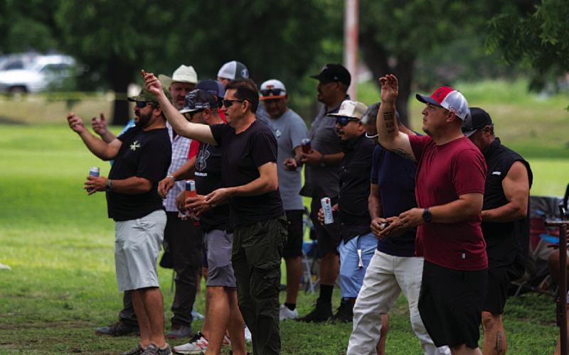 HUNTER KING | DISPATCH RECORD A group of competitors toss their washers into the air.