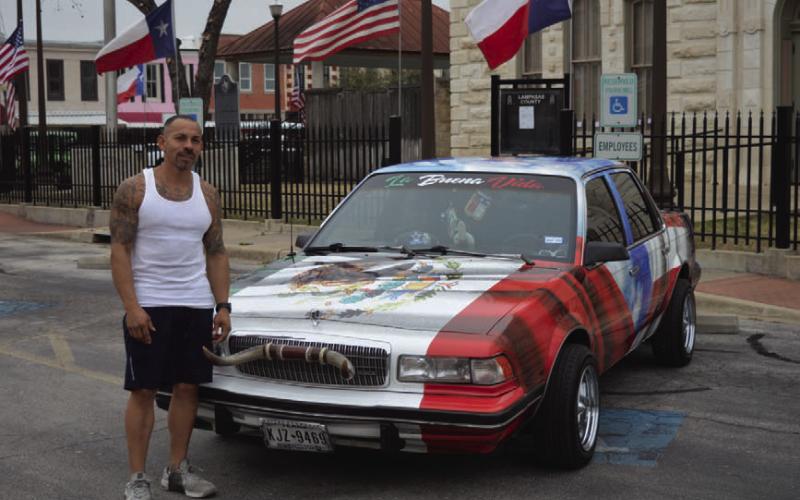 Lampasas resident Robert Sanzhez stands next to his 1991 Buick Century outside the Lampasas County Courthouse. The Mexican coat of arms that is present on the Mexican flag of a golden eagle eating a rattlesnake can be seen on the hood of the car. ERICK MITCHELL | DISPATCH RECORD