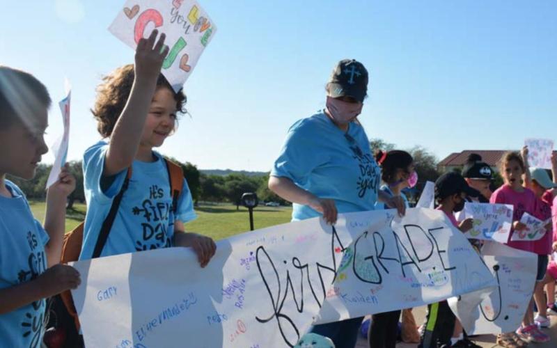 CJ’s classmates and teachers greeted him with signs Thursday morning. MONIQUE BRAND | DISPATCH RECORD