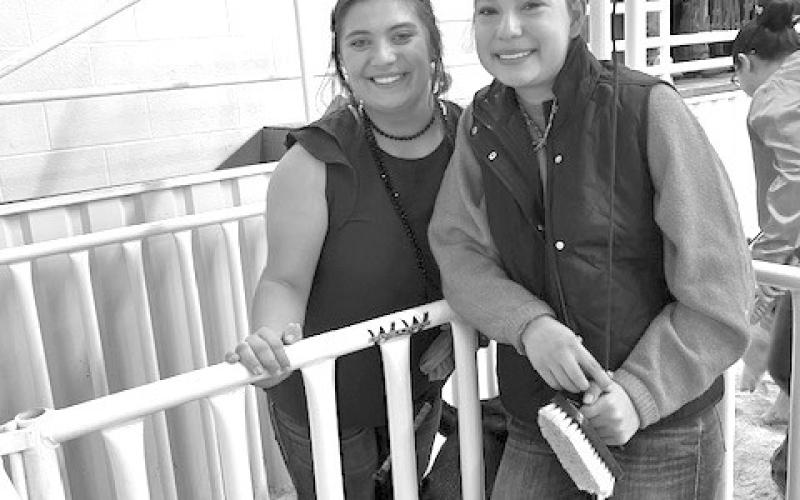 Ava Rojas, at left, stands alongside Emory Vineyard at the Lampasas County Youth Livestock Show in January. Vineyard credits Rojas for helping her improve at competitions. COURTESY PHOTO