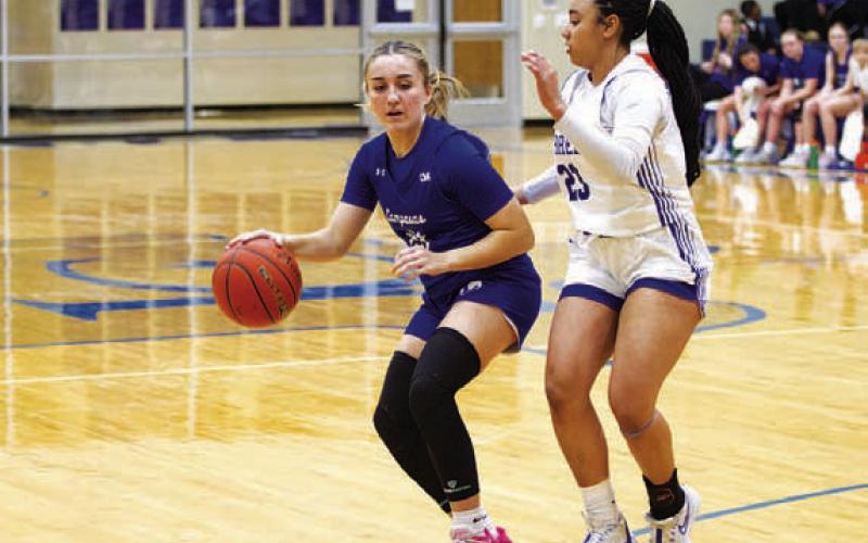Payton Crawford tries to dribble past a Jarrell defender. HUNTER KING | DISPATCH RECORD