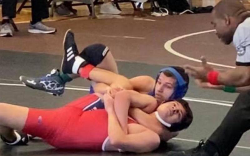 Rylan Myers, back-center, wrestles his way to second place at the district tournament in College Station on Thursday. LAURA MARTELL | COURTESY PHOTO