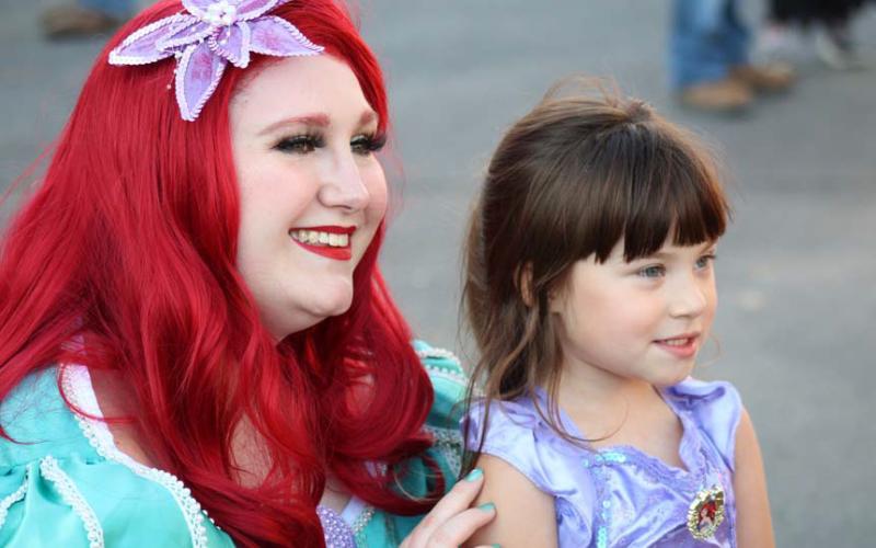 Four-year-old Reagan Hetrick, right, shares a happy moment with her fellow mermaid, Princess Ariel at Squared SIlly. The annual Halloween and costume event took place at the Lampasas courthouse square on Saturday. joycesarah mccabe | dispatch record