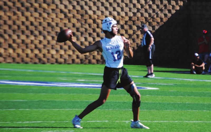 Dylan Sanchez reaches back to pass during 7-on-7 action Monday. HUNTER KING | DISPATCH RECORD