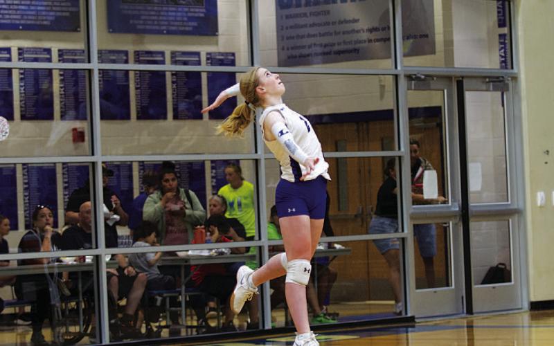 Ellie Felkner serves during the Lady Badger volleyball team’s match against Jarrell.