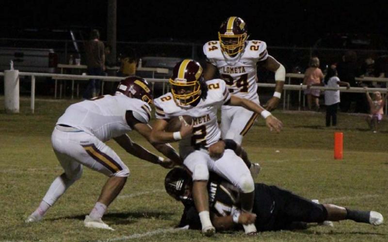 Tim Juarez tries to break an Evant tackle while running toward the end zone during Lometa’s 51-6 win over the Elks last week. JESSICA MALDONADO | DISPATCH RECORD