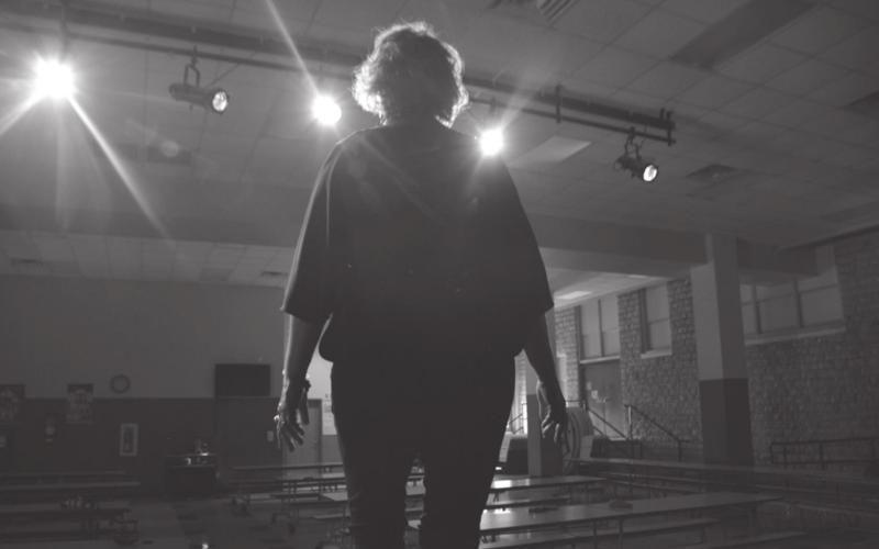 Lometa ISD theater director Elizabeth Dickison stands on stage under the lights one last time Wednesday afternoon. She will retire from the education field after 41 years — 39 of those spent in Lometa. MONIQUE BRAND | DISPATCH RECORD