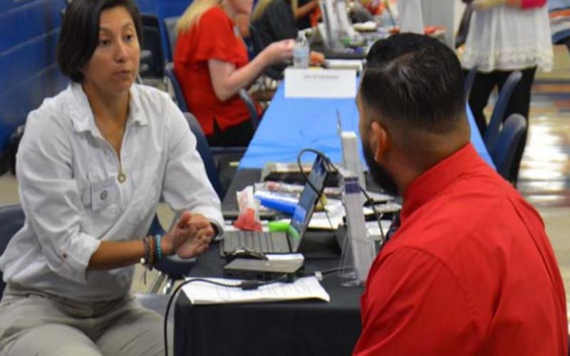 Maria Gonzalez of the Texas Veterans Commission speaks with Jose Garcia at last week’s job fair. MASON HINES | DISPATCH RECORD