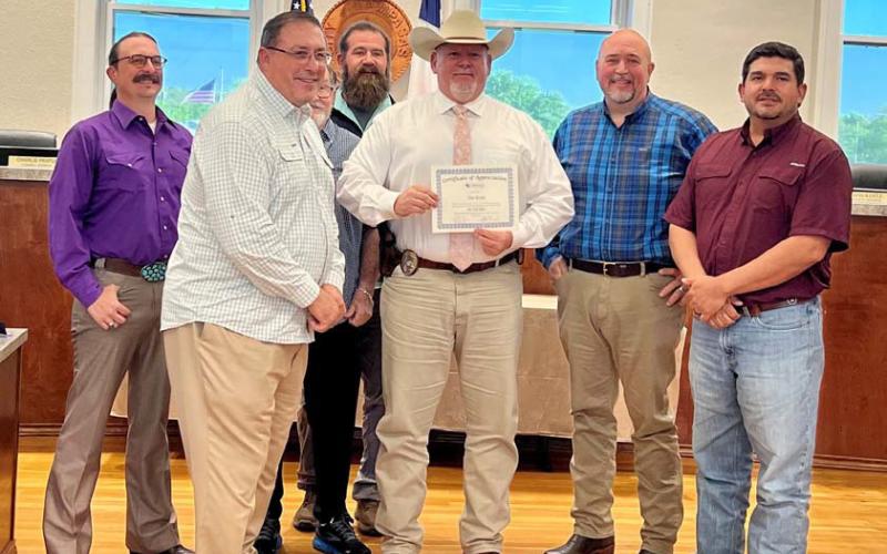 At the March 25 Lampasas City Council meeting, council members recognized Lampasas Police Sgt. Investigator Tim Ryan for his 30 years of service with the department. He is pictured here with Mayor Herb Pearce and members of the council. COURTESY PHOTO | CITY OF LAMPASAS