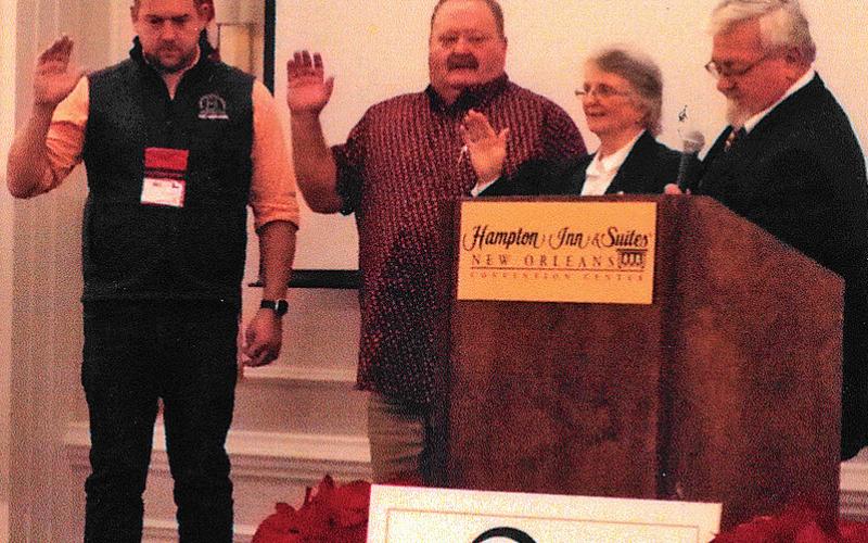 Clovia Ketchum, second from right, is sworn in as president of the National Young Farmers Education Association. Also installed were, from left, James Wood of Indiana, secretary; and Rusty Tipton of Kentucky, president-elect. Handling the officer installation is Donnie Carter of Georgia, past president of NYFEA. courtesy photo