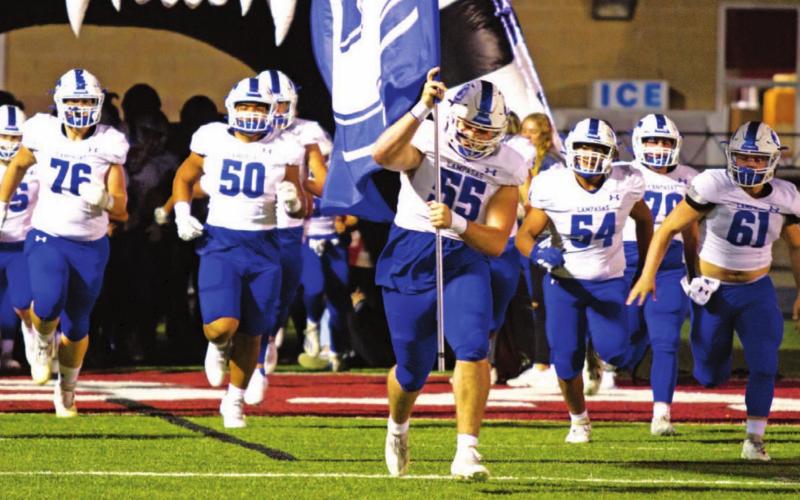 Conner Keele leads the Badgers onto the field in their final regular-season game of 2021 against Fredericksburg. FILE PHOTO