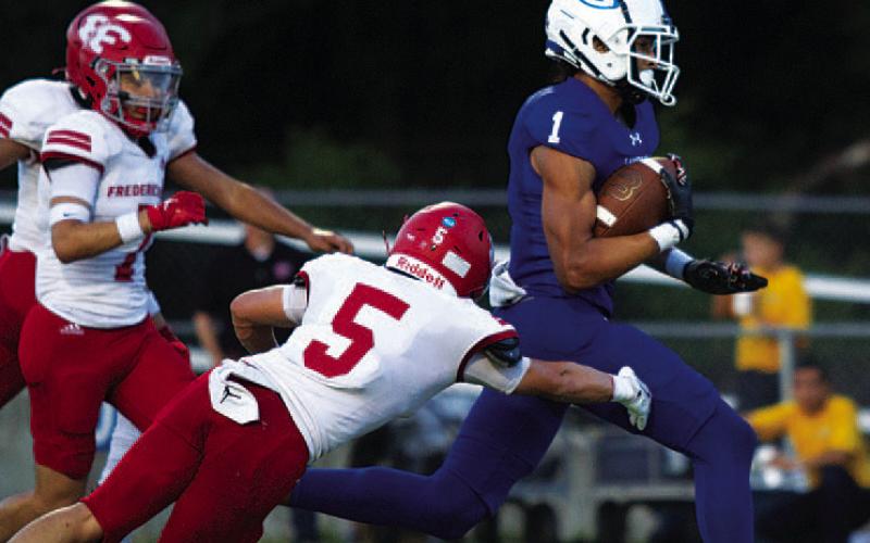 HUNTER KING | DISPATCH RECORD Ty Johnson runs away from Fredericksburg defenders for a touchdown in the first quarter.