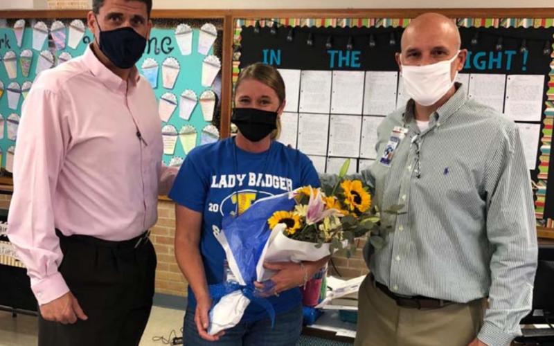 Superintendent Dr. Chane Rascoe, left, and Lampasas Middle School Principal Dana Holcomb congratulate Lacey Plouff on her selection as LISD Secondary Teacher of the Year. COURTESY PHOTO