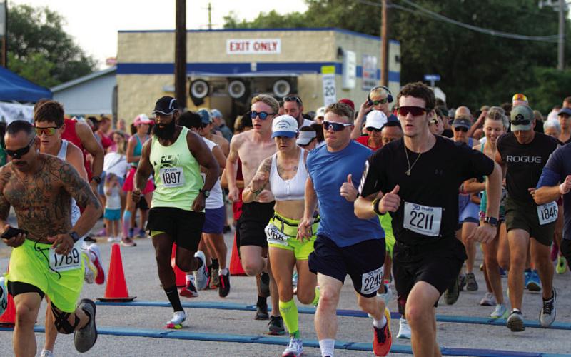 10K runners take off from the starting line at last Saturday’s event.