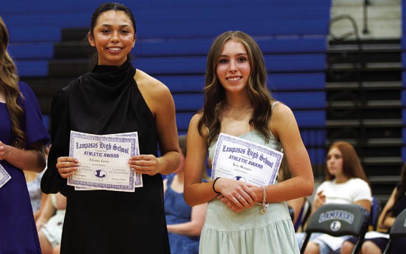 Johnnie Lewis, left, and Kase Bumpus show their certificates from the banquet. HUNTER KING | DISPATCH RECORD