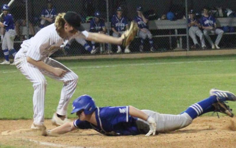Gauge Gholson slides into first base in a previous district game. Gholson reached base twice against Stephenville, the district leader, on Tuesday. CHRIS YBARRA | DISPATCH RECORD