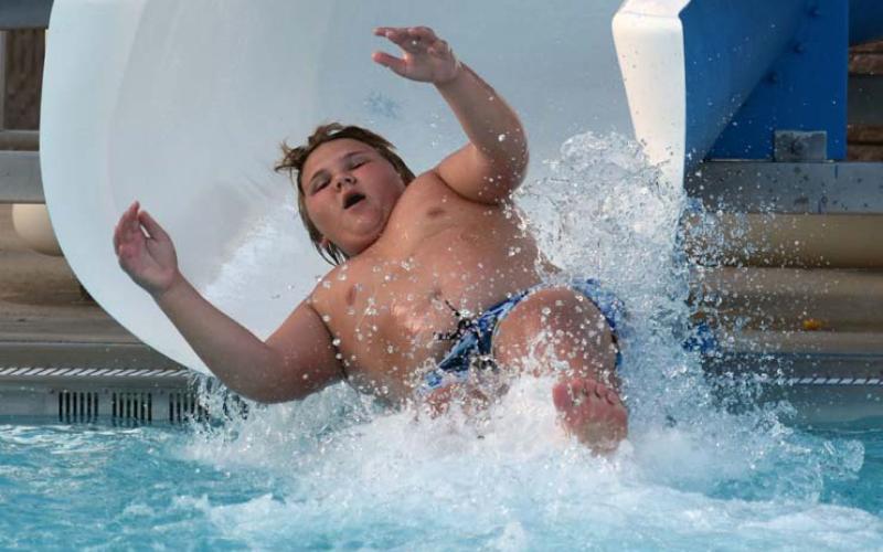 Zane Lee uses the water slide during the Teen Scene event at the Hanna Springs Pool on Saturday. JOSEPH NEUENSCHWANDER | LAMPASAS DISPATCH RECORD