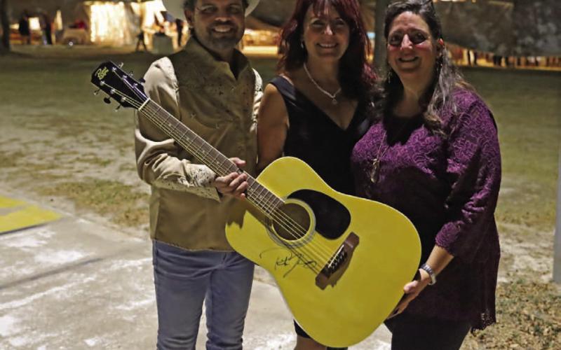 Boots and Blazers Ball benefits local art scene Texas country music artist Rick Trevino presents a signed guitar to LAFTA board members Debbie Reynolds, center, and Catherine Kuehne for auction at the Boots and Blazers Ball on Saturday evening. Proceeds of the auction benefited the Lampasas Association for the Arts. MICHAEL KUEHNE | K DIGITAL PRO