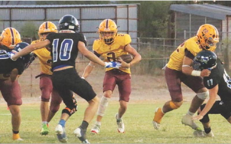 Stone Carr-Jones (2) looks for room to run while Lukas Smailus-Cruz (22), Jacob Wooten (25, far left) and Jordan Livesay (3, middle) set up blocks. MEGAN LUSTY | COURTESY PHOTO