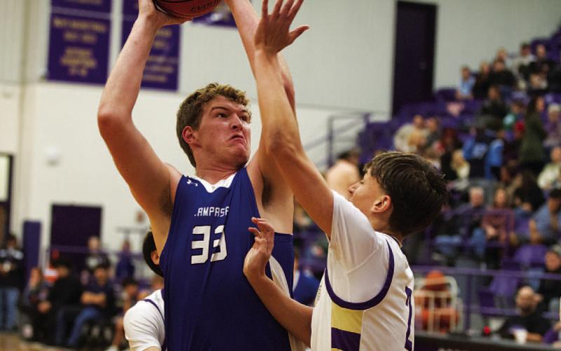 Beau Patterson rises up over a defender for a shot in the paint last Friday night. HUNTER KING | DISPATCH RECORD