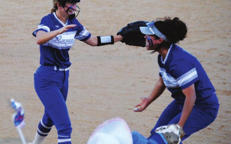Hadley Oncken, left, runs to hug Alycia Cantu after the final out was recorded to beat Graham. HUNTER KING | DISPATCH RECORD