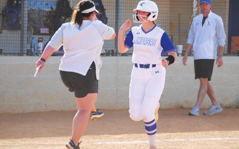 Kamryn Kothmann smiles and celebrates with coach Jessica Harborth after her three-run homer in last Thursday’s game. HUNTER KING | DISPATCH RECORD