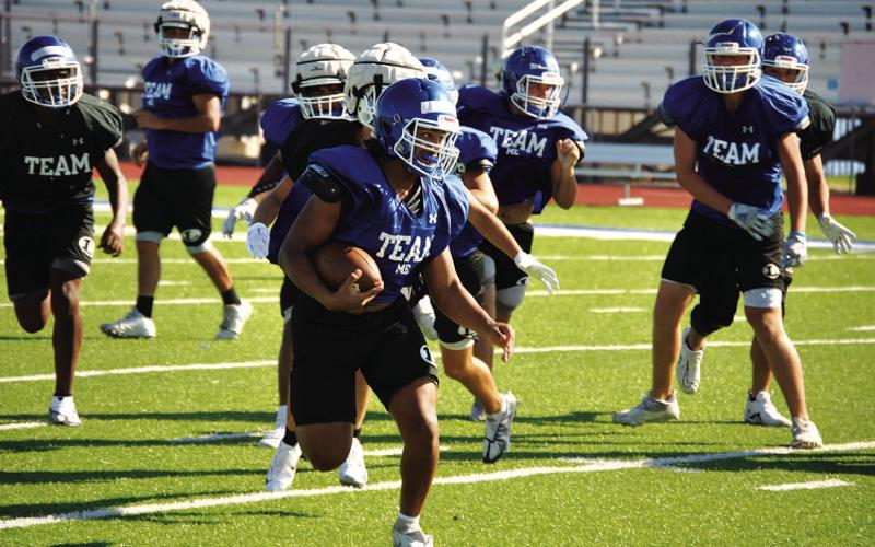 HUNTER KING | DISPATCH RECORD Dailin Fagan looks up field for defenders during a practice last week. He will take his varsity carry tonight in Elgin.