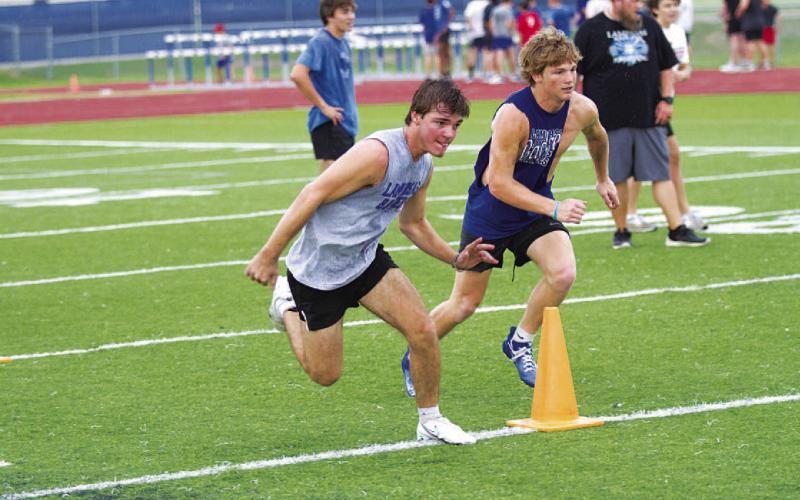 FILE PHOTO Competition is a big part of the SWAT workouts as well. Shawn Roberts, left, and Kayden Vanpelt race during an agility drill.