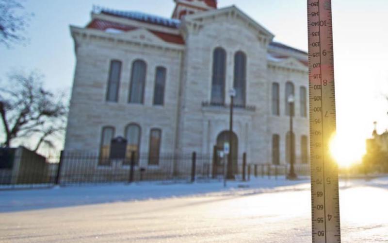 A ruler measures about two inches of snow on the courthouse square Monday morning. Downtown Lampasas was deserted much of the weekend, and high temperatures Sunday were about 40 degrees lower than average for mid-February. JEFF LOWE | DISPATCH RECORD