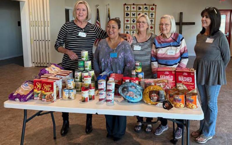 The ’36 Club took up Thanksgiving donations for a November community service project. Pictured with the food donations are Projects Committee members. Courtesy photo